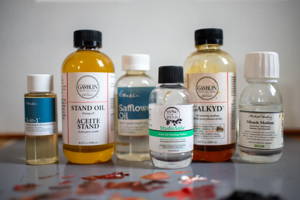 Best Oil Painting Supplies: My Must-Have Tools for Brushes, Mediums, Surfaces & More 2025 3 Selection of oil painting mediums and solvents including Gamblin Stand Oil, Galkyd, Safflower Oil, and StudioSolv on studio table
