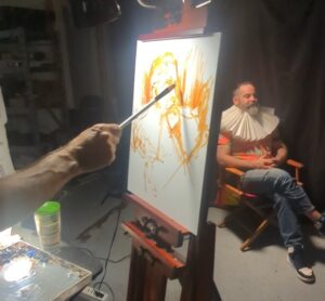 Artist painting on a handcrafted linen panel, highlighting texture and surface quality of locally made art supplies.